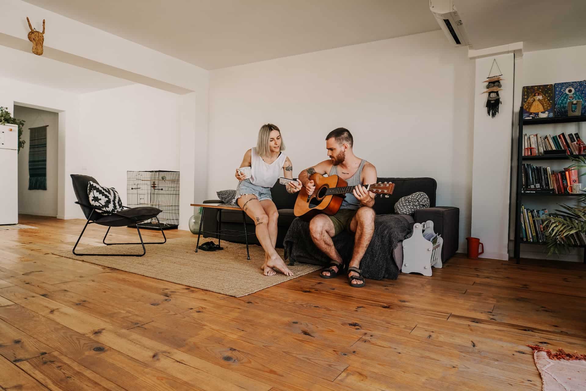 How To Learn Guitar In Home - Man And Woman On Couch Playing Guitar