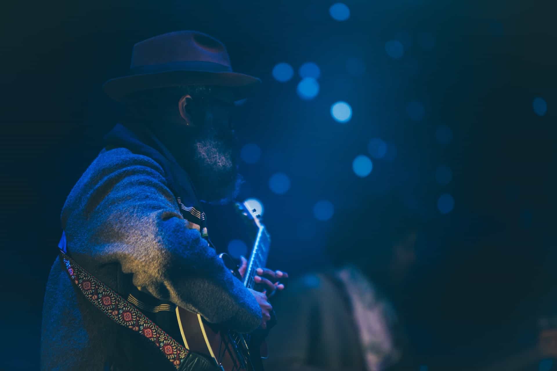 best way to learn blues guitar - man playing guitar on stage