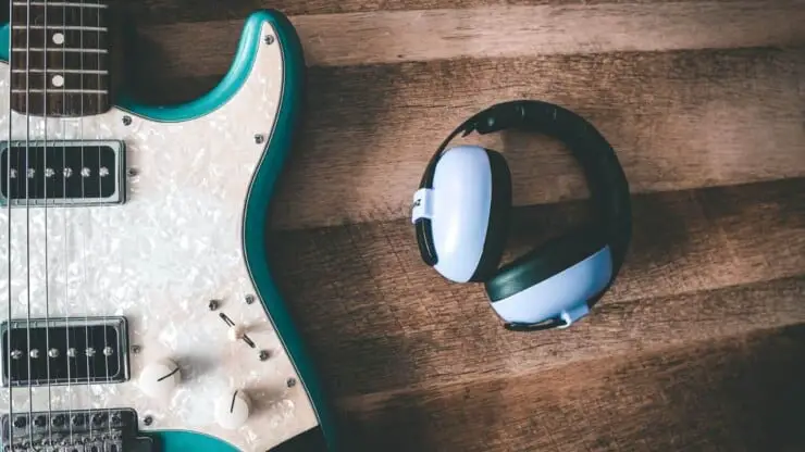 electric guitar and headphone on table