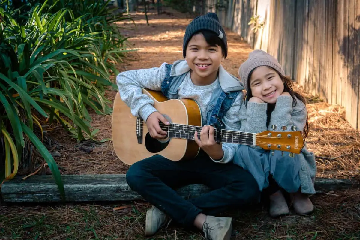 how to teach a child to play guitar - boy and girl are playing guitar