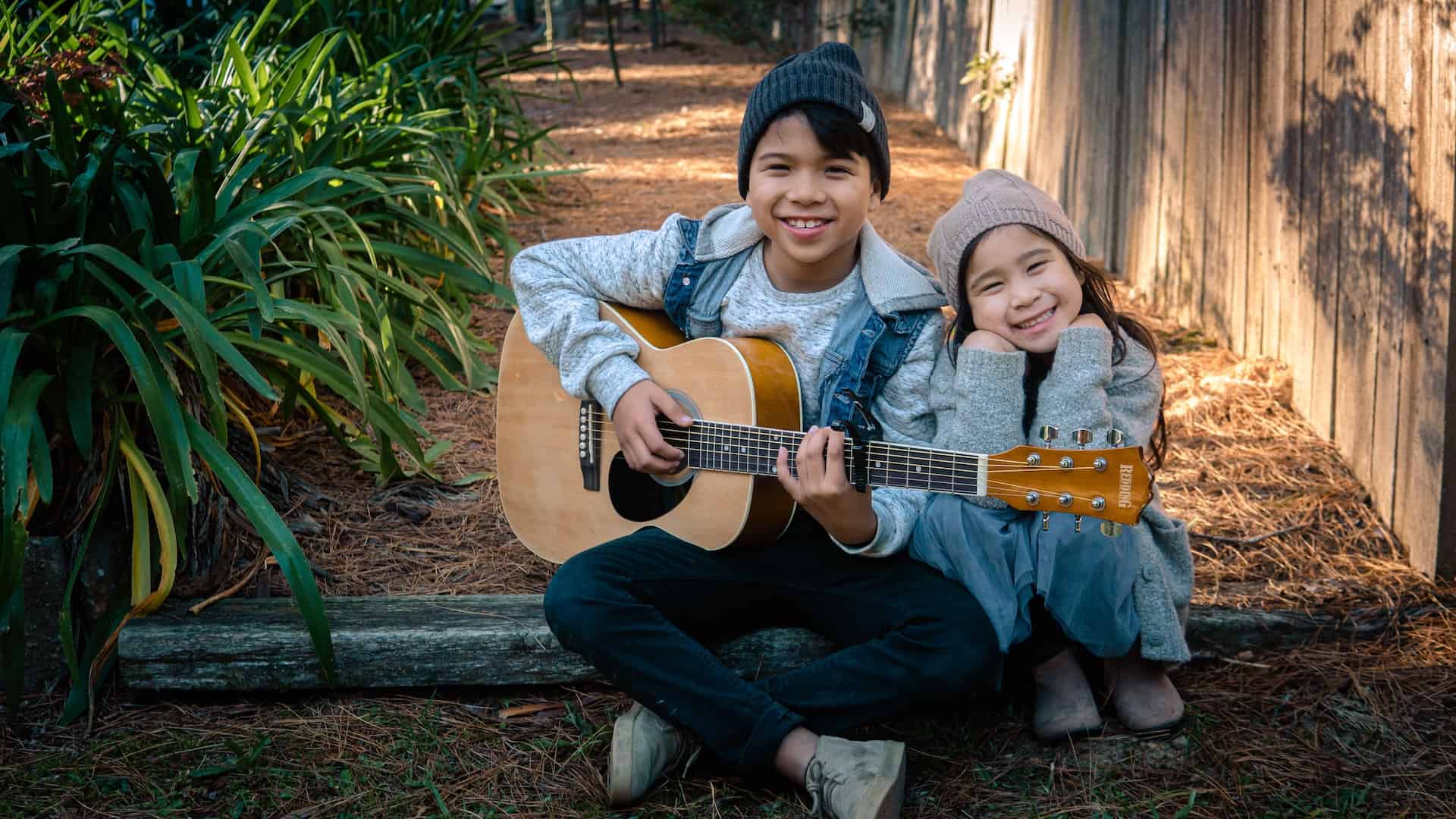 how to teach a child to play guitar - boy and girl are playing guitar