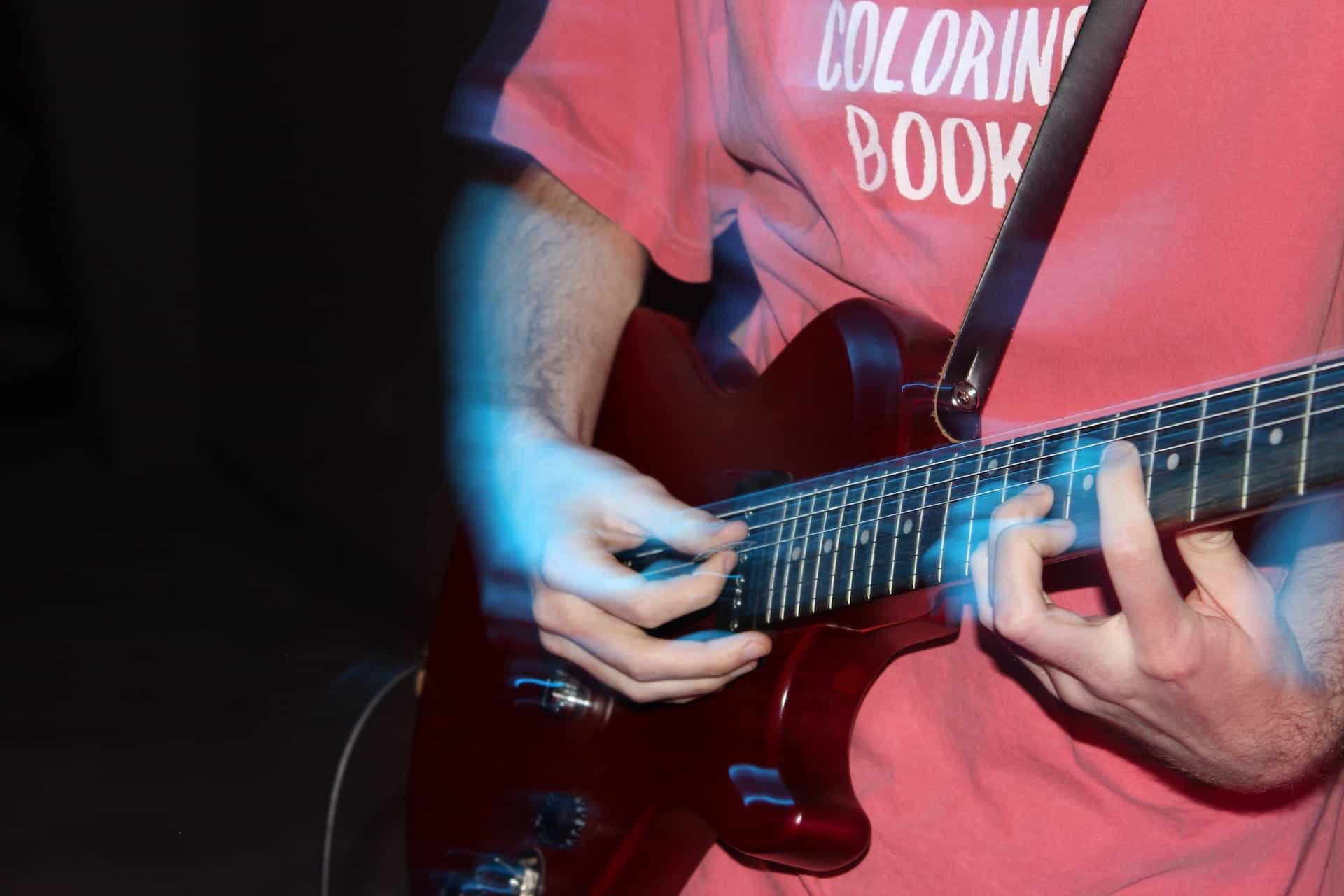 is it easier to learn electric guitar than acoustic - man playing electric guitar