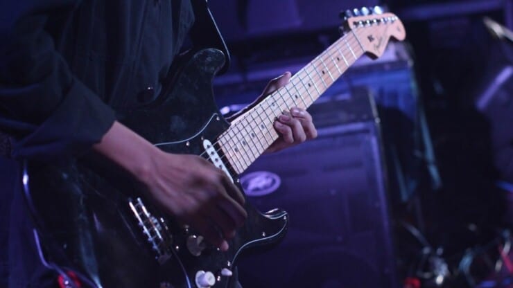 man playing guitar without a pedal