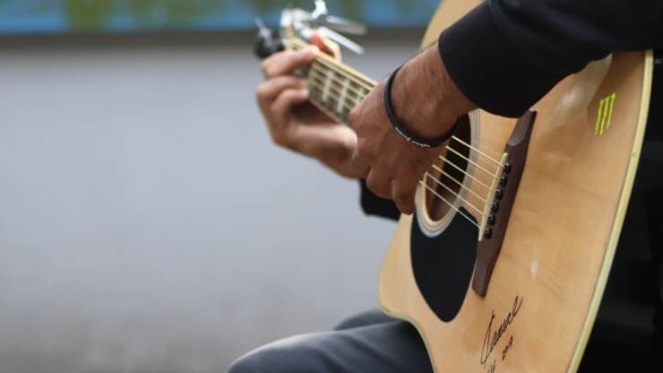 man playing peavey acoustic guitar