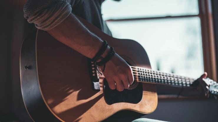 man with guitar wearing wristband