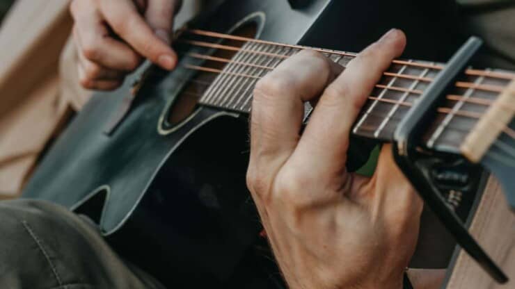 mans finger almost bleeding in playing guitar